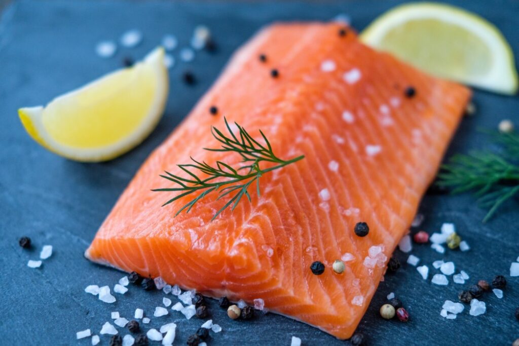 HEART HEALTHY FOODS 1 RAW SALMON LEMON SALT AND PEPPER ON THE BACKGROUND OF STONE T20 E82BQO